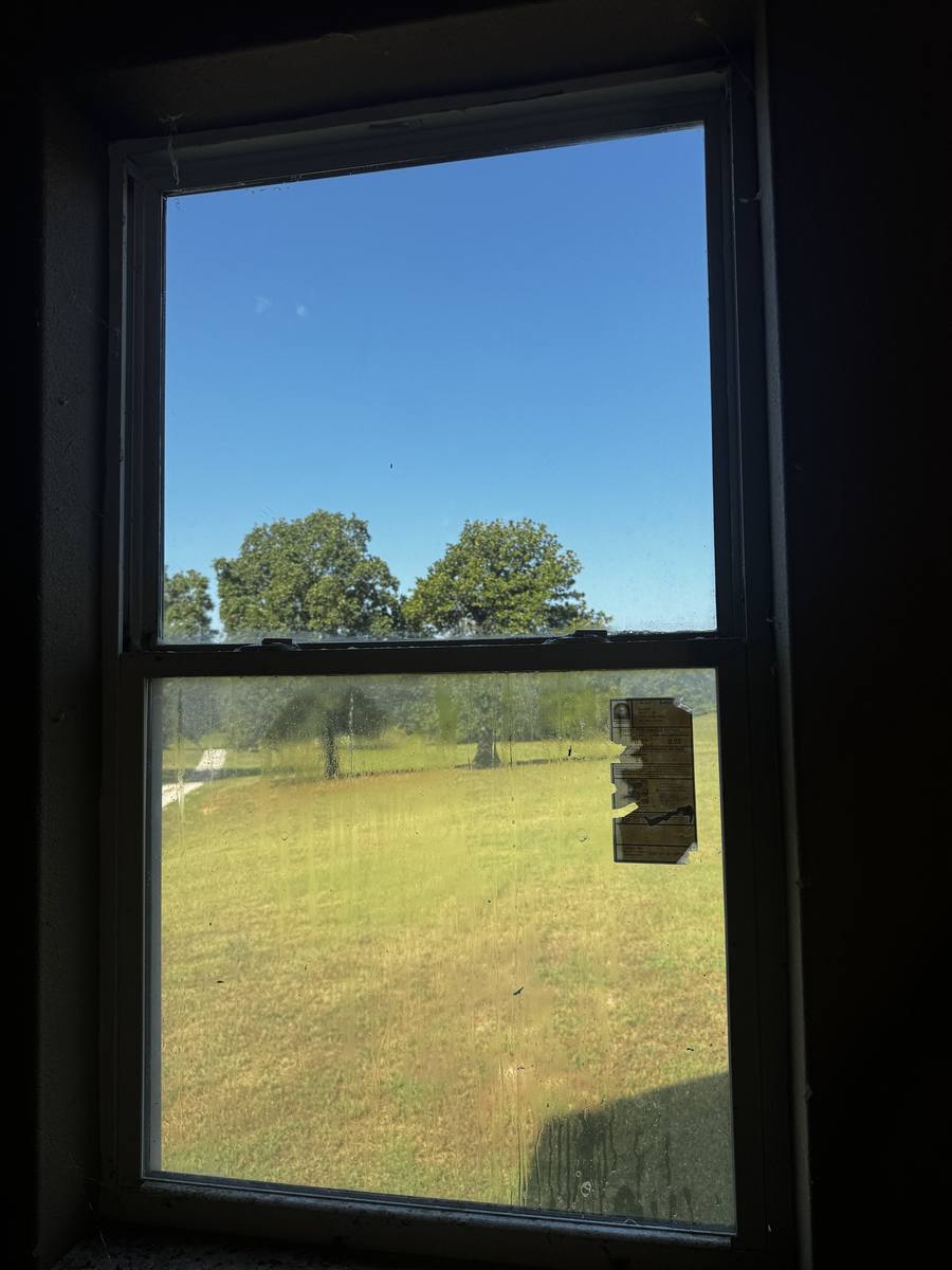 Dirty double-hung window before cleaning, DFW home
