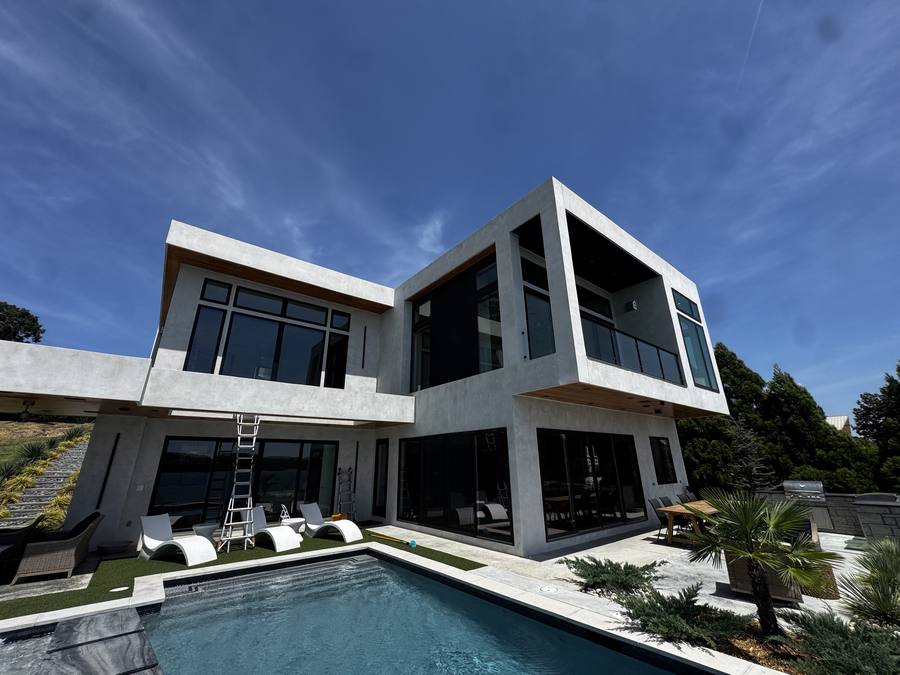Modern lake house with full-height glass after window cleaning